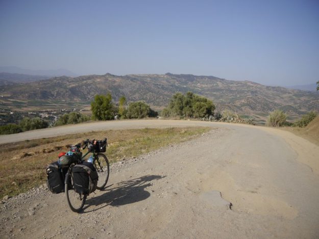 Dusty mountain road and bicycle, Morocco