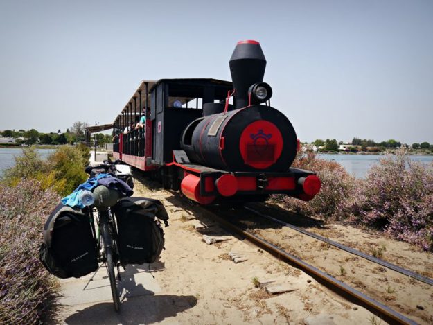 the tourist train running across a beach island in the Algarve