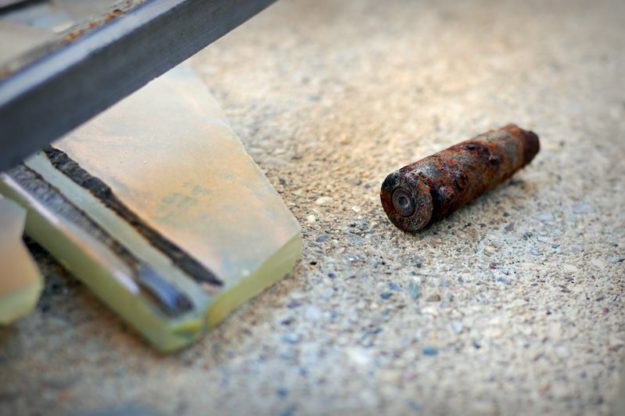 A rusty sniper bullet found on the floor inside the sniper tower.