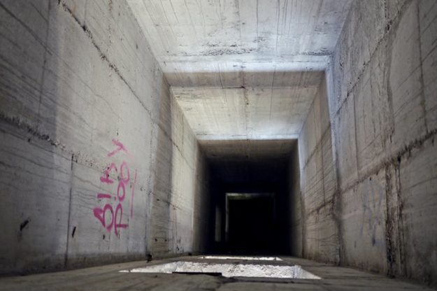 Peering down the empty lift shaft.