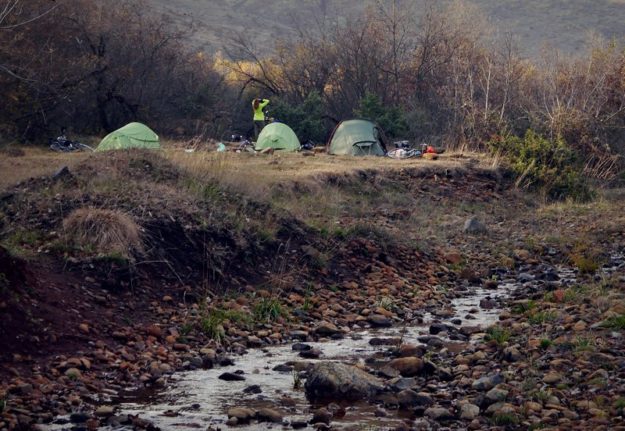 Tents and wild camping in Kosovo next to river.
