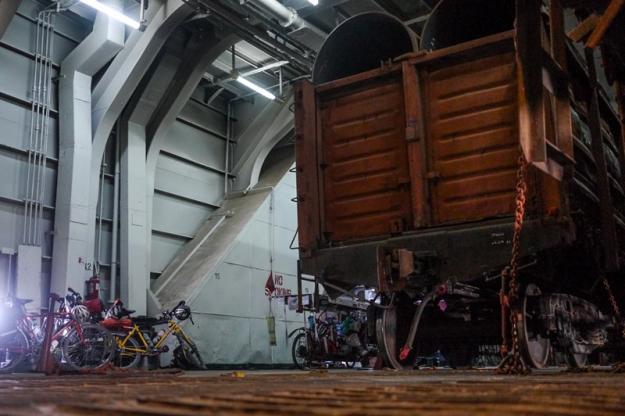 Our bicycles next to one of the train carriages on the boat.