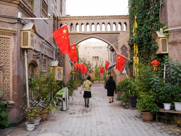 Kashgar flags and street Fake paved roads, concret and Chinese flags in Kashgar